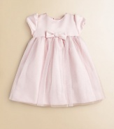 A dazzling design featuring short puff sleeves, a center bow and full, glittery skirt for precious moments.JewelneckShort puff sleevesBack buttonsGathered waist with bowFull skirtPolyester tulleDry cleanImported Please note: Number of buttons may vary depending on size ordered. 