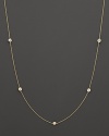 A yellow gold necklace with bezel-set diamond stations. With signature ruby accent. Designed by Roberto Coin.