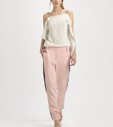 Tailored silk trousers have zippers at each side that adjust to reveal contrast inset panels.Bandless waistBelt loopsZip flySmooth frontWorking zippers at each side seam, from above the knee to the ankleBack besom pocketsRise, about 11Inseam, about 30½SilkDry cleanImported