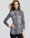 XCVI creates allure with ruched seaming and a chic anaconda print on this day-to-night turtleneck.