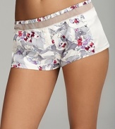 Elegant floral print sleepshorts with contrast side panels and sheer mesh details at waist.