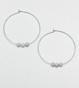 From the Brilliance Collection. A slender wire hoop, adorned with three sparkling beads, creates a look of understated glamour.GlassSilvertoneDiameter, about 1.25PiercedImported