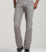 These straight leg 7 for All Mankind jeans in a faded gray wash sit low on the waist with a slim fit through hip and thigh and slight tapering at the ankle. Back pocket signature squiggle detail.