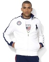 A versatile track jacket in a trim, modern fit is crafted from stretch cotton mesh with athletic stripes and country details, celebrating Team USA's participation in the 2012 Olympic Games.