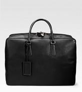 An elegant travel tote in saffiano leather with a full-zip closure and straps inside. Zip closure Top handles ID tag 20W X 14H X 7D Made in Italy 