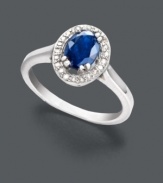 Petite elegance. This sophisticated beauty features a faceted oval-cut sapphire (1 ct. t.w.) with a sparkling halo of round-cut diamond accents. Ring crafted in sterling silver. Size 7.