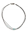 Earthy style with a hint of natural color. This simple three strand necklace by Fossil features turquoise resin and metal beads strung on dark natural leather cord. Brass tone mixed metal setting and button closure. Approximate length: 18 inches.