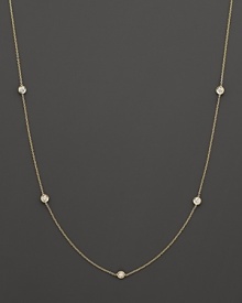 A yellow gold necklace with bezel-set diamond stations. With signature ruby accent. Designed by Roberto Coin.