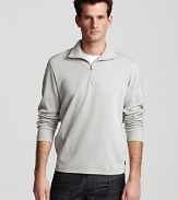 Sleek 1/4 zip sweater with woven textures at shoulder and sleeve.