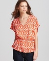 In a rich ikat print and a vibrant orange hue, this Aqua blouse lends luxe style.