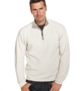 A crisp white quarter zip-up sweater is an eye-catching novelty amid the dark colors of fall. Made by Izod, the sweater is 100% cotton--a desirable material for the months leading up to winter.