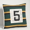 Inspired by a vintage rugby uniform, this pillow in striped cotton jersey sports a well-worn 5 patch atop a canvas square with printed signatures in different front for a handcrafted look.