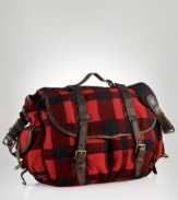 Leather accents and ample pockets lend rugged utilitarian appeal to a messenger bag in buffalo-checked wool.