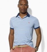 Vibrant pops of color and Ralph Lauren's iconic pony enliven a trim-fitting short-sleeved polo crafted from soft jersey-knit cotton with sleek stripes.