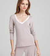 A long sleeve pajama top with a satin trim V-neckline. Pair it with Calvin Klein's matching pajama pants to complete the look.