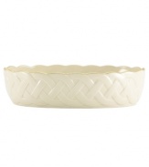 Created to commemorate the 120th anniversary of Lenox, this delightful serving bowl brings timeless elegance to any arrangement in your home. Crafted of ivory porcelain, it features a winding latticework motif, accented by a gold band at the rim. With a special 120th anniversary back stamp. From Lenox's collection of serveware and serving dishes. Qualifies for Rebate