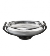 Set or simply decorate the table with the ultra-modern Anvil bowl from Nambe's collection of serveware and serving dishes. A sculptural, iron-finished base cradles lustrous silvertone alloy in this innovative Neil Cohen design.