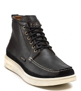 A handsomely rugged boot from Paul Smith rendered with a moc toe, contrast stitching and chunky contrast rubber sole.