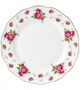 Revive a classic dinnerware pattern with the Vintage dinner plate. Lush pink blossoms plucked from the Old Country Roses collection flower on white bone china with a ruffled gold edge.