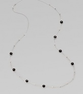 A long sterling silver chain with hammered bead and faceted onyx stations.Onyx Sterling silver Length, about 38 Lobster clasp closure Imported 