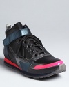 Sneaker collector or fashionista-on-the-go, you'll love Jill Sander's futuristic take on the high top sneaker, accented with metallic and neon coral touches.