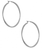 A classic hoop silhouette will never let you down. Nine West's sleek earrings finish off your everyday look. Finished with a click closure. Crafted from imitation rhodium tone mixed metal. Approximate diameter: 2 inches.