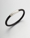 A simple design with modern sensibilities defines this woven leather bracelet, accented by a sterling silver clasp.LeatherSterling silverAbout 3 diam.Made in the United Kingdom