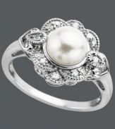 Vintage elegance. This stunning antique-inspired ring features an intricate round-cut diamond sunburst design (1/5 ct. t.w.) surrounding a cultured freshwater pearl (8 mm). Set in sterling silver. Size 7.