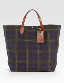 A handsome tote in a heritage-rich tartan plaid canvas, finished with supple calfskin trim and custom-made brass hardware. Snap closure Top handle Leather ID tag Interior pockets Fully lined 15¼W X 20H X 5D Imported 