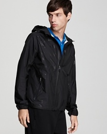 Burberry's lightweight nylon hooded jacket with zip front, Burberry Sport logo along the right side, two front zip pockets and a zip chest pocket .