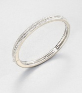 Double rows of sparkling pavé crystals encircle a classic hinged bangle with a modern square-edged design.CrystalRhodium platingDiameter, about 2½Width, about ¼Box-and-tongue claspImported