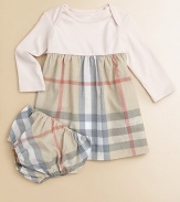 A t-shirt soft top is joined by a woven checked skirt in this adorable design that dresses up your little one in cotton comfort.Round ribbed necklineEnvelope shoulders for pullover easeLong sleevesGathered Empire waistFull woven skirtMatching bloomers with elasticized waist and leg openingsCottonMachine washImported