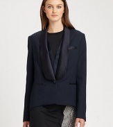 A modern variation on the traditional tuxedo, with feminine touches including an extended satin collar