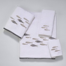 Luxurious sheared velour towel is embellished with a school of embroidered silver metallic fish swimming across the towel. Finished with a coordinating silver fabric trim.