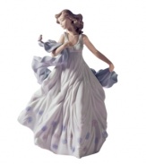 A fairytale moment in glazed porcelain, Lladro's Summer Serenade figurine depicts a gorgeous young woman captivated by the call of a feathered friend.