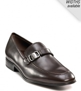 Sleek and stylish slip-on dress shoes with leather strap and buckle detail at top. Round toe. Gancini insignia etched on buckle and heel. Leather sole with slightly stacked heel.