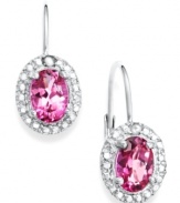 Pink perfection. Victoria Townsend's sparkling drop earrings highlight oval-cut pink topaz (2-1/5 ct. t.w.) surrounded by round-cut diamond accents. Set in sterling silver. Approximate drop: 3/4 inch.