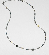 From the Bijoux Collection. Richly colored semi-precious stones in various colors and shapes mix with 18k gold beads on a delicate blackened sterling silver link chain. Hematite, labordarite, grey moonstone and blue topaz18k goldBlackened sterling silverLength, about 40Toggle closureImported 