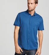 HUGO riffs on the classic polo, adding a button front and round hem.