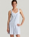 A sleeveless chemise with a lace pleated V-neckline and button front.