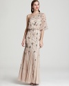 This light-as-air Adrianna Papell one-shoulder gown is splashed with sparkling sequin clusters for an ultra-glam finish.