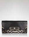 Snake leather and leopard prove a fierce combination on Sam Edelman's sleek clutch. Tuck the savage beauty under your arm with a colorful dress and head out for a wild night.