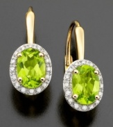 Enjoy August's birthstone with these beautiful earrings featuring oval-cut peridot (1-3/4 ct. t.w.) and diamond accents set in 14k gold. Approximate drop: 1-3/4 ct. t.w.)