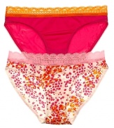 A solid or printed bikini with contrast scalloped lace trim along waistline.