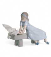 Feathered friends. Three little birds eat right out of the hands of a gentle young lady dressed in a pretty blue dress and shoes. A classic Lladro collectible in handcrafted porcelain.