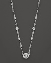 A white gold necklace has double-sided diamond stations; with signature ruby accent. Designed by Roberto Coin.