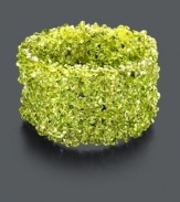 Go green in a whole new way with this organic cuff. Bracelet features bright green peridot chips (4-6 mm) and stretches to fit the wrist. Approximate length: 4 inches.