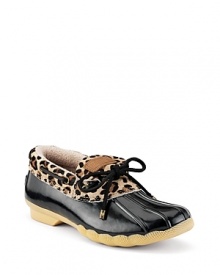 Classic rain shoes with a wild twist. Rubber shoes with leopard print haircalf cuffs and a contrast bow detail.