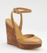 A richly stained wood wedge and platform sit underneath a leather sandal with a shapely closed toe and slender ankle strap.Wood wedge, 5½ (140mm) Wood platform, 1 (25mm) Compares to a 4½ heel (115mm) Buckle ankle strap Leather lining and sole Padded insole ImportedOUR FIT MODEL RECOMMENDS ordering one half size up as this style runs small. 