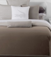 Add a touch of sophistication to your Doradus bed from Lacoste with this sham, featuring a sleek ombré hue on crisp cotton percale. Finished with white cord trim and embroidered croc logo for added detail. Button closure.